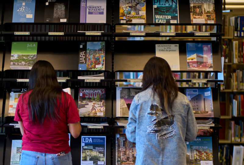 Two students on a tour of design library