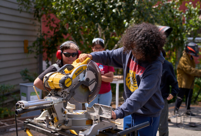 Student and mentor working miter saw