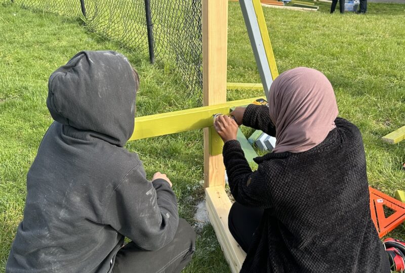 Students installing fence board