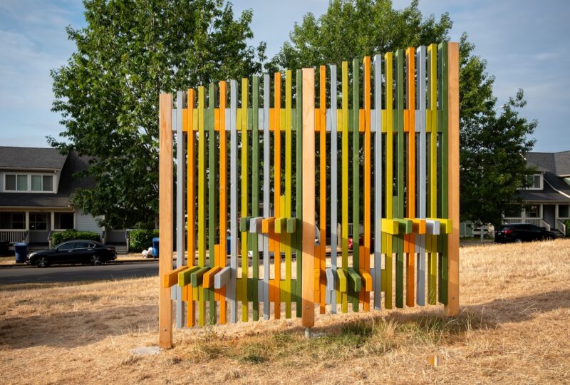 Finished panel of fence and seating structure with colorful wood